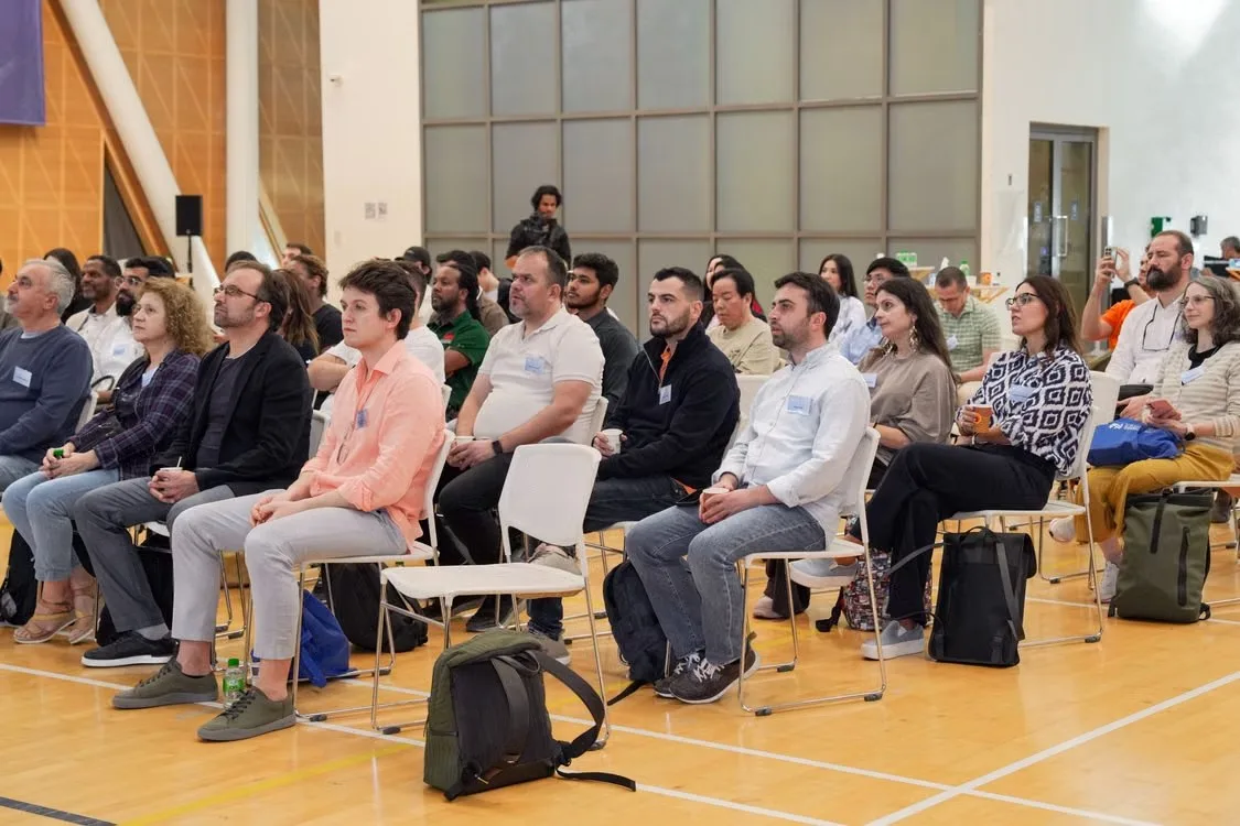 A seated audience listening in a hall
